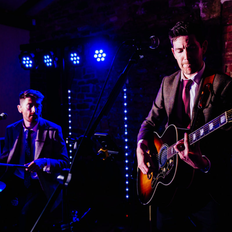 Two men playing music at a wedding