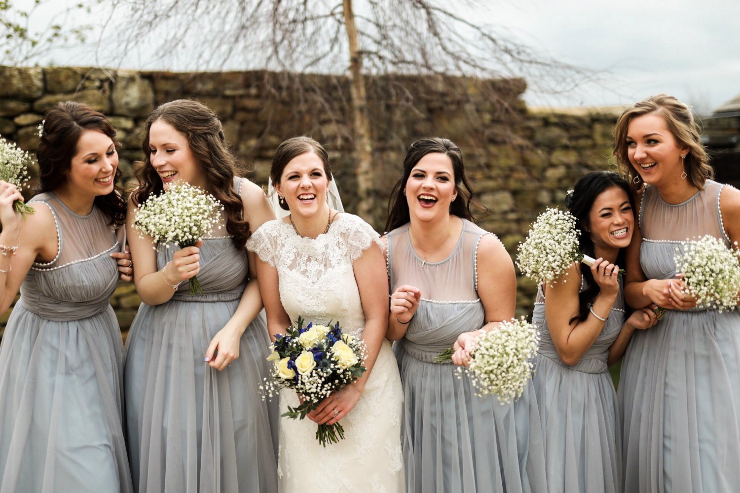 Bride and bridesmaids laughing